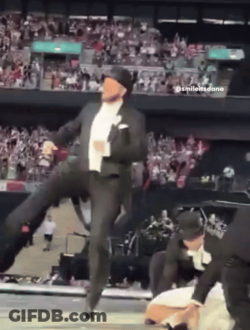 Man In Suit And Hat Dancing On Stage GIF