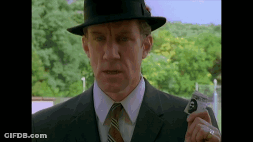 Man In Suit And Hat Holding Card With Face GIF