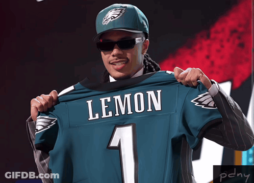 Man In Suit And Hat Holding Lemon Jersey GIF