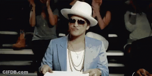 Man In Suit And Hat Holding Paper In Front Of Crowd GIF