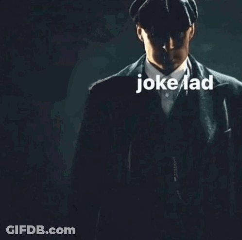 Man In Suit And Hat In Dark With Jokelad GIF