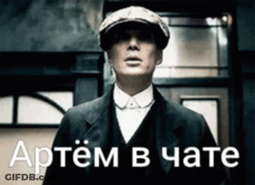 Man In Suit And Hat In Front Of Russian Building GIF