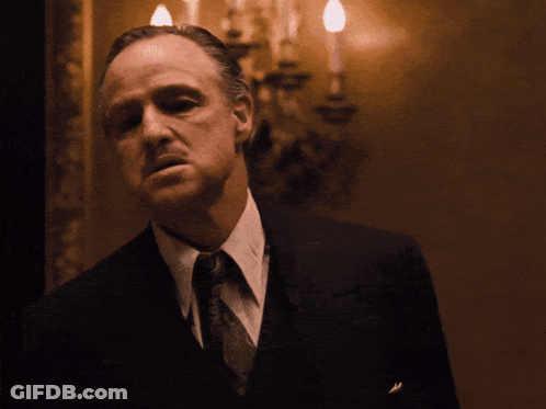 Man In Suit And Hat In Park With Trees GIF
