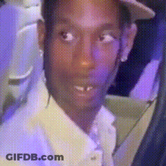 Man In Suit And Hat Looking At Camera On Purple Background GIF