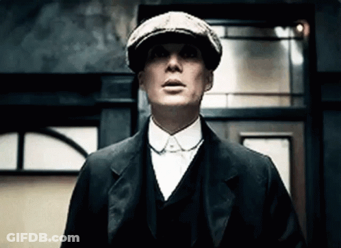 Man In Suit And Hat Looking Up At Building GIF