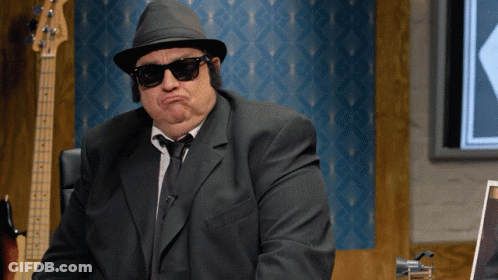 Man In Suit And Hat Making A Face GIF