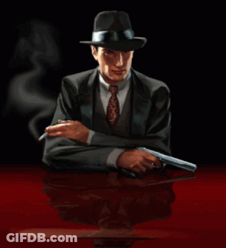 Man In Suit And Hat Smoking Cigarette Holding Gun GIF