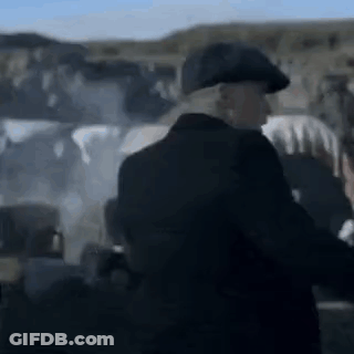 Man In Suit And Hat Standing Before Group GIF