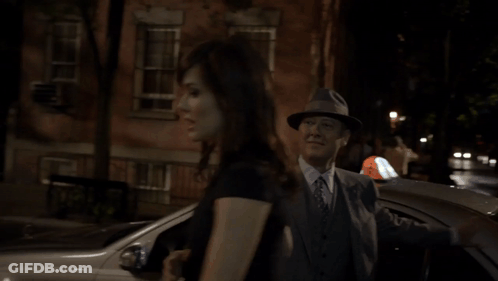 Man In Suit And Hat Talking To Woman GIF