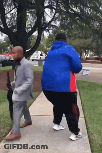 Man In Suit And Man In Blue Jacket Walking GIF