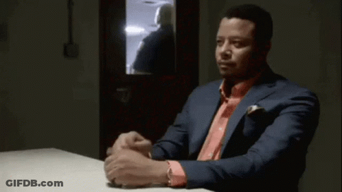 Man In Suit And Pink Shirt At Table GIF