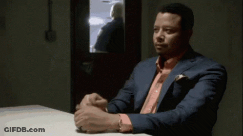 Man In Suit And Pink Shirt Sitting At Table Hands Folded GIF