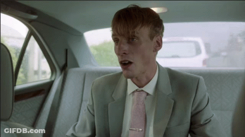 Man In Suit And Pink Tie Sitting In Car GIF