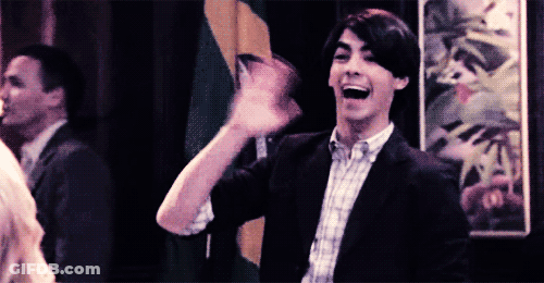 Man In Suit And Plaid Shirt Waving GIF