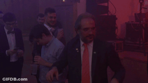 Man In Suit And Red Tie In Dark Room GIF