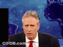 Man In Suit And Red Tie In Front Of World Map GIF