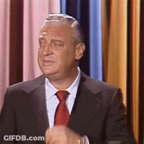 Man In Suit And Red Tie Making A Face GIF
