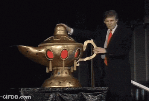 Man In Suit And Red Tie Next To Giant Lamp GIF