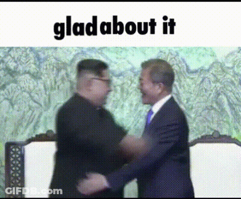 Man In Suit And Scarf Looking At Camera GIF