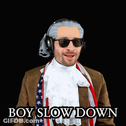 Man In Suit And Scarf Wearing Sunglasses And Headphones GIF