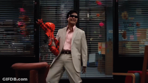 Man In Suit And Sunglasses Holding Inflatable Tigger GIF