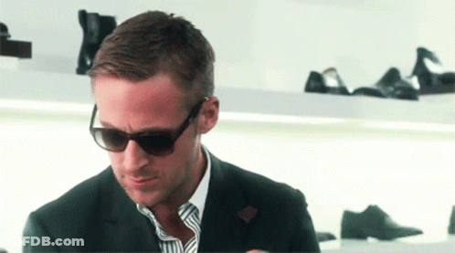 Man In Suit And Sunglasses Looking Down GIF