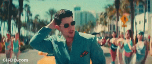 Man In Suit And Sunglasses On Street With Group Of Women GIF