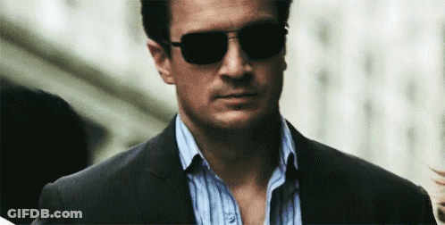Man In Suit And Sunglasses Walking Down Street GIF