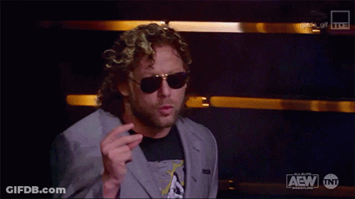 Man In Suit And Sunglasses With AEW Logo GIF