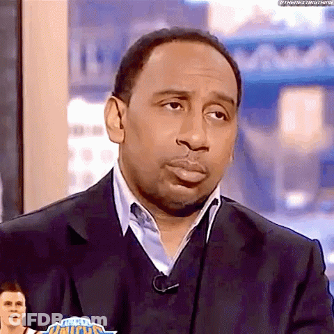 Man In Suit And Sweater On TV Show GIF