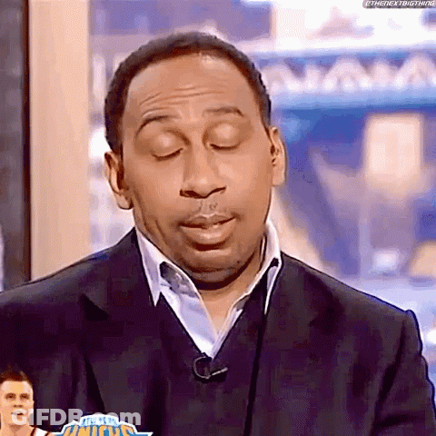 Man In Suit And Sweater On TV Show GIF