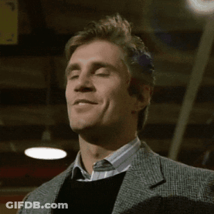 Man In Suit And Sweater Smiling At Camera GIF