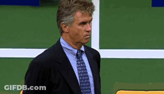 Man In Suit And Tie Against Green Wall GIF