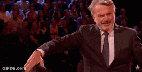 Man In Suit And Tie Arms Outstretched Crowd GIF
