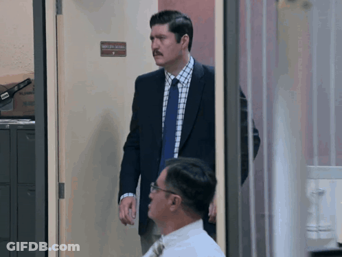 Man In Suit And Tie At Attorney General Door GIF