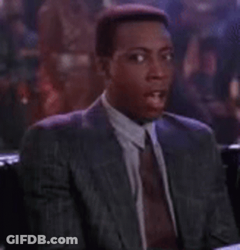 Man In Suit And Tie At Bar Table GIF