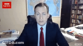 Man In Suit And Tie At BBC News Screen GIF