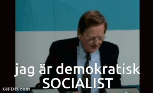 Man In Suit And Tie At Desk Jag Ar Demokratisk Socialist GIF