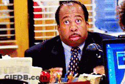 Man In Suit And Tie At Desk GIF
