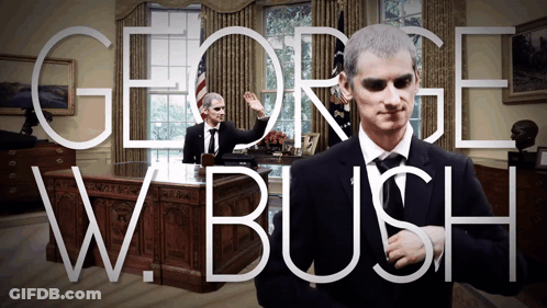 Man In Suit And Tie At Desk GIF