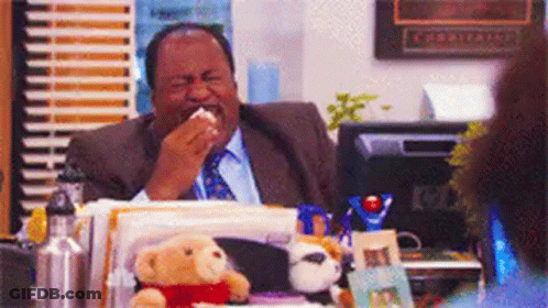Man In Suit And Tie At Desk With Stuffed Animals GIF