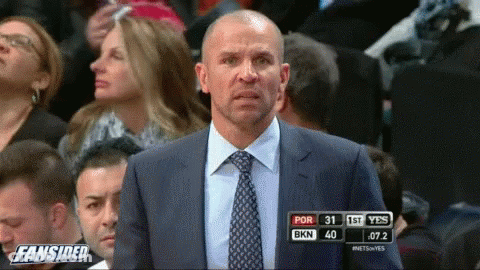 Man In Suit And Tie At Fansided Scoreboard GIF