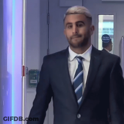 Man In Suit And Tie At Fire Door GIF