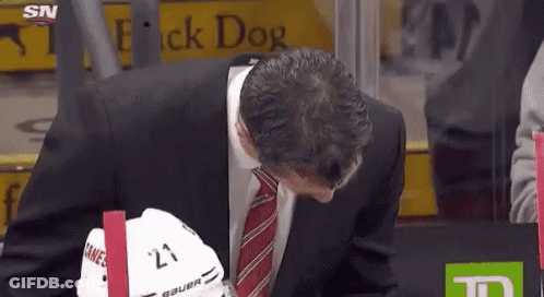 Man In Suit And Tie At Flick Dog Sign GIF