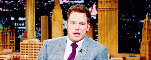 Man In Suit And Tie At Microphone GIF