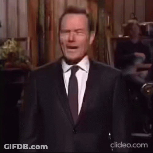 Man In Suit And Tie At Microphone On Stage GIF