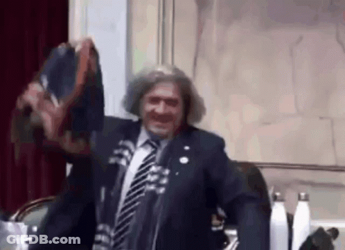 Man In Suit And Tie At Microphone GIF