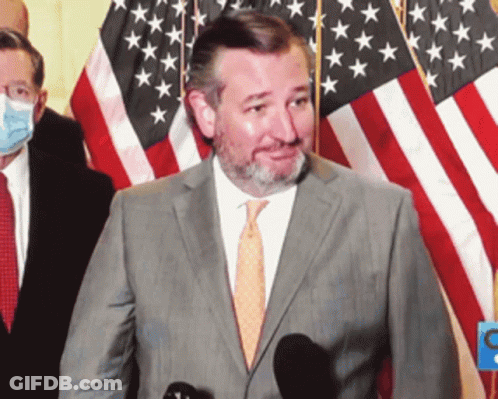 Man In Suit And Tie At Microphone With American Flag GIF