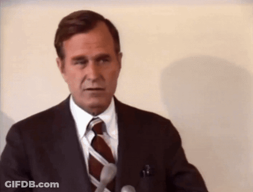Man In Suit And Tie At Podium GIF