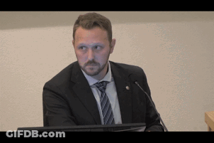 Man In Suit And Tie At Podium GIF